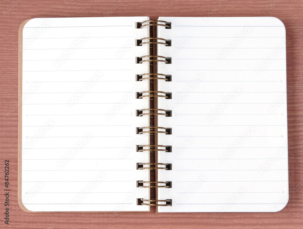 Blank notebook on wood table background, top view Blank notebook on wood table background, top view