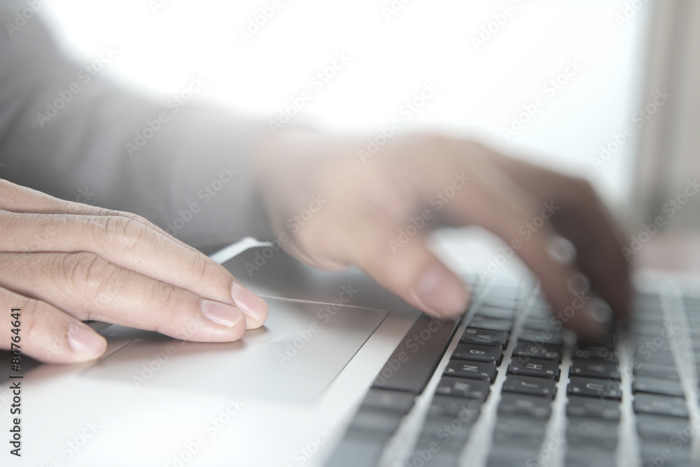 Close up of business man hand working on laptop computer with so Close up of business man hand working on laptop computer with so