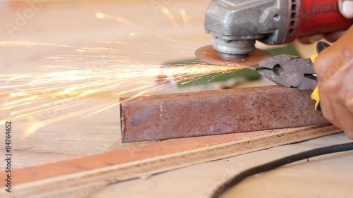 Sparks Fly from an Angle Grinder Tradesman Tool - Slider