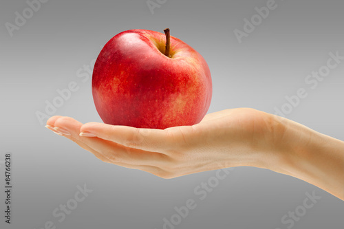 Female hand with red apple