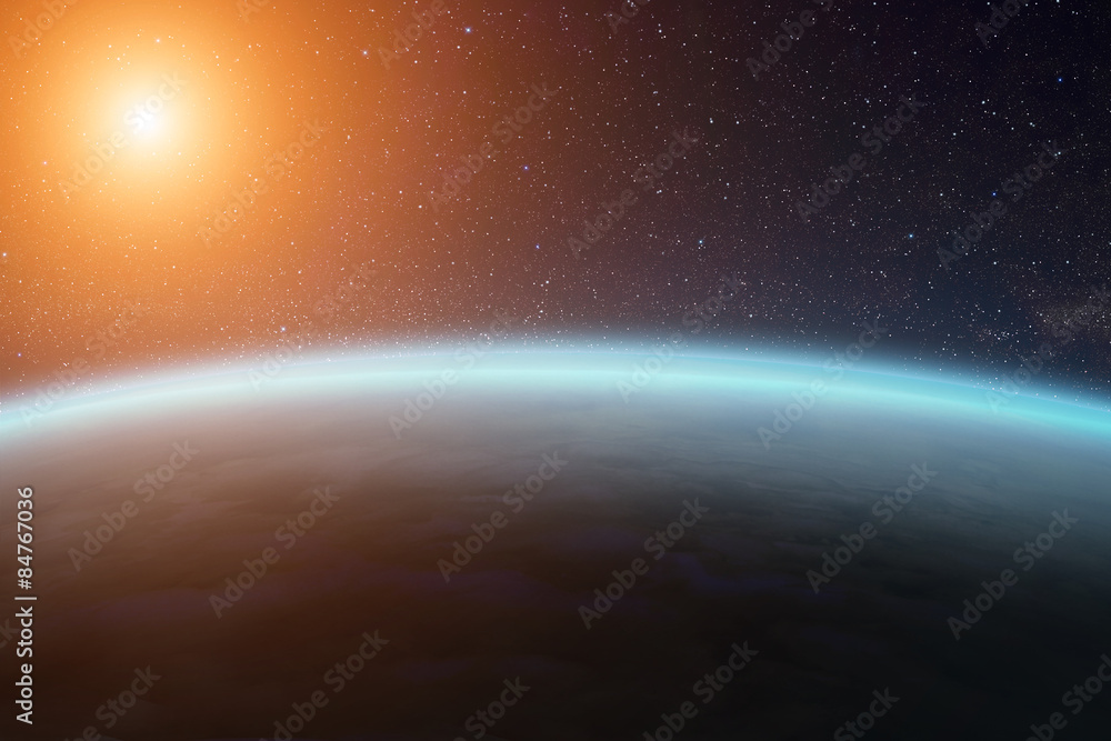 Fototapeta premium Sunrise over planet Earth in space