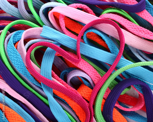 Colorful shoe laces and heart shaped pink shoelace photo