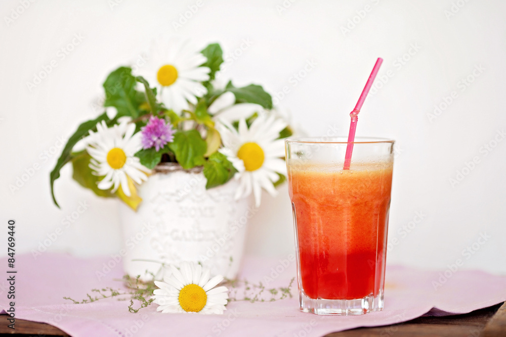 Strawberry, orange and apple fresh in a glass with a lined straw Strawberry, orange and apple fresh in a glass with a lined straw