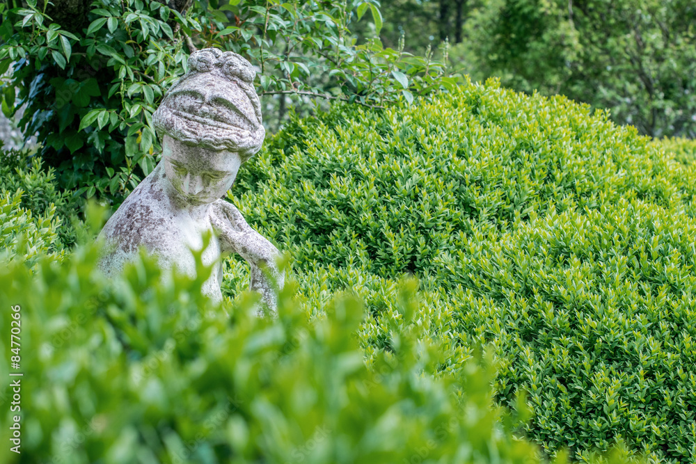 Garden statue hidden in hedge