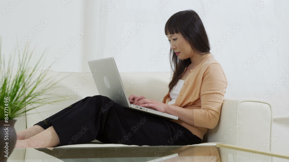 Portrait of Asian woman at home with laptop computer Portrait of Asian woman at home with laptop computer