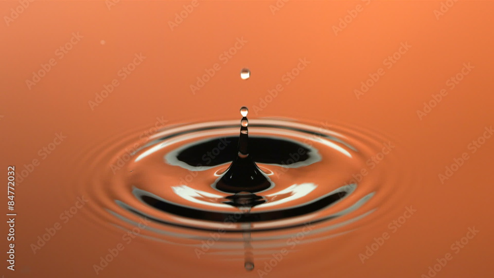 Slow motion water droplet, orange Stock Video Adobe Stock