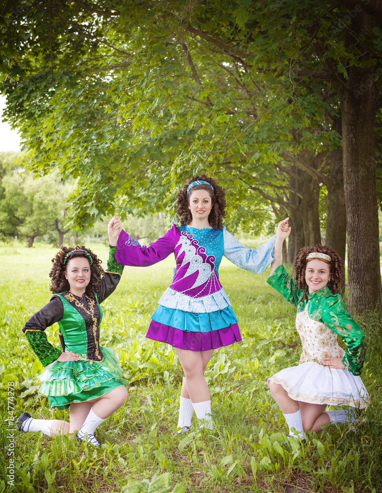 Fototapeta premium Three young beautiful girls in irish dance dress posing outdoor