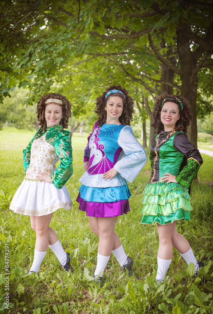 Fototapeta premium Three young beautiful girls in irish dance dress posing outdoor
