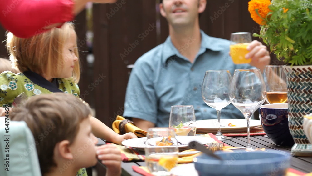 Family or friends enjoying dinner on the patio Family or friends enjoying dinner on the patio