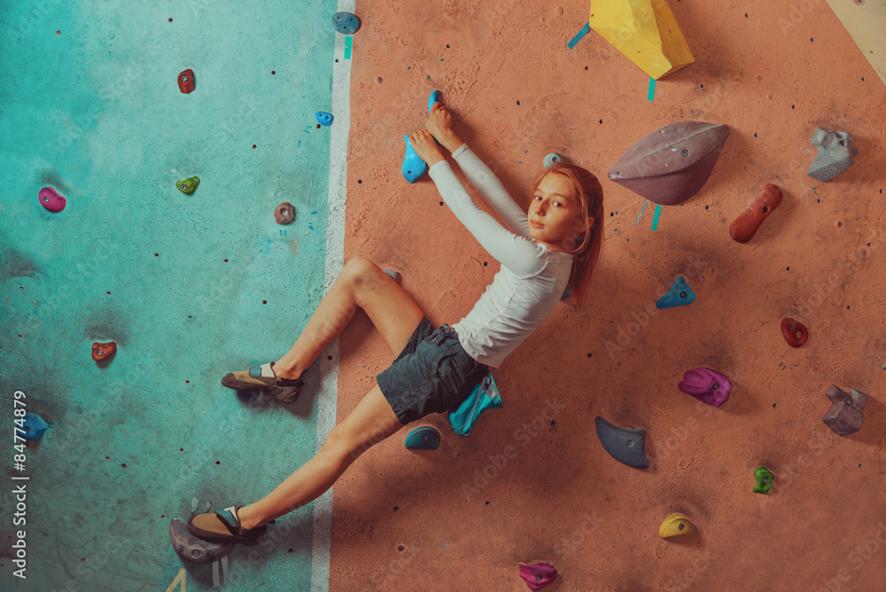 Fototapeta premium Sporty little girl climbing indoor