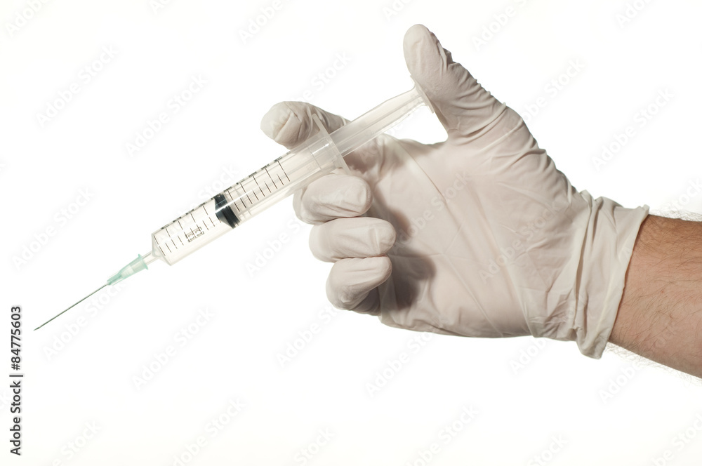 Hand holding a syringe Hand holding a syringe