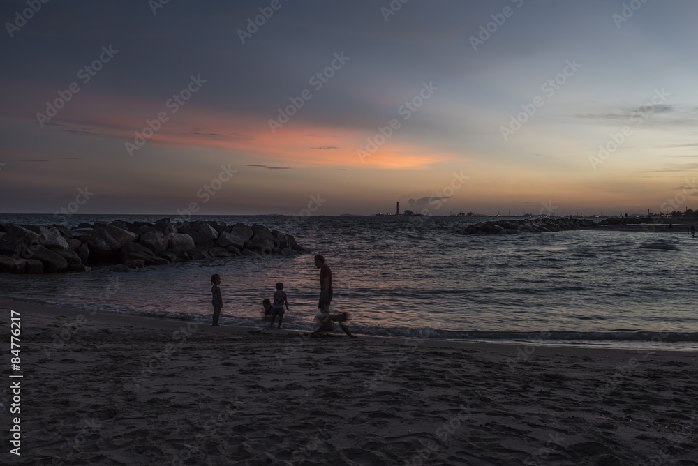 Silhouette  happy family  enjoy running on the sunset beach, Thailand. 