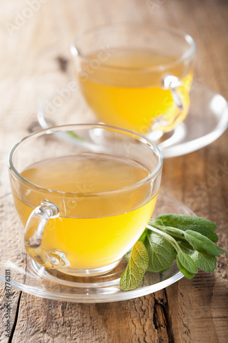 herbal sage tea with green leaf in glass cup