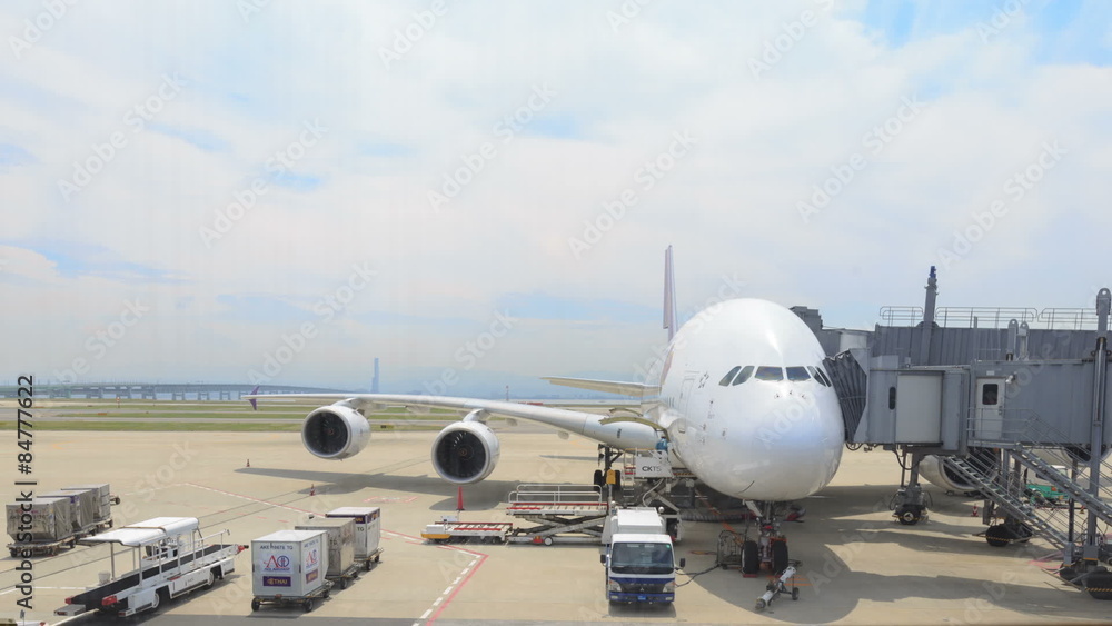 OSAKA, JAPAN - MAY 25: Time Lapse of Workers in Kansai Airport loading plane cargo watching from window in boarding room on May 25, 2015 OSAKA, JAPAN - MAY 25: Time Lapse of Workers in Kansai Airport loading plane cargo watching from window in boarding room on May 25, 2015
