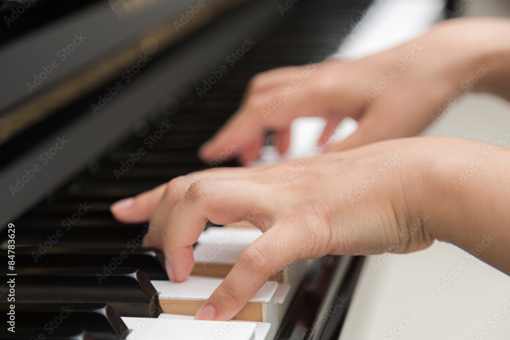 Obraz premium Close up of woman hands playing piano