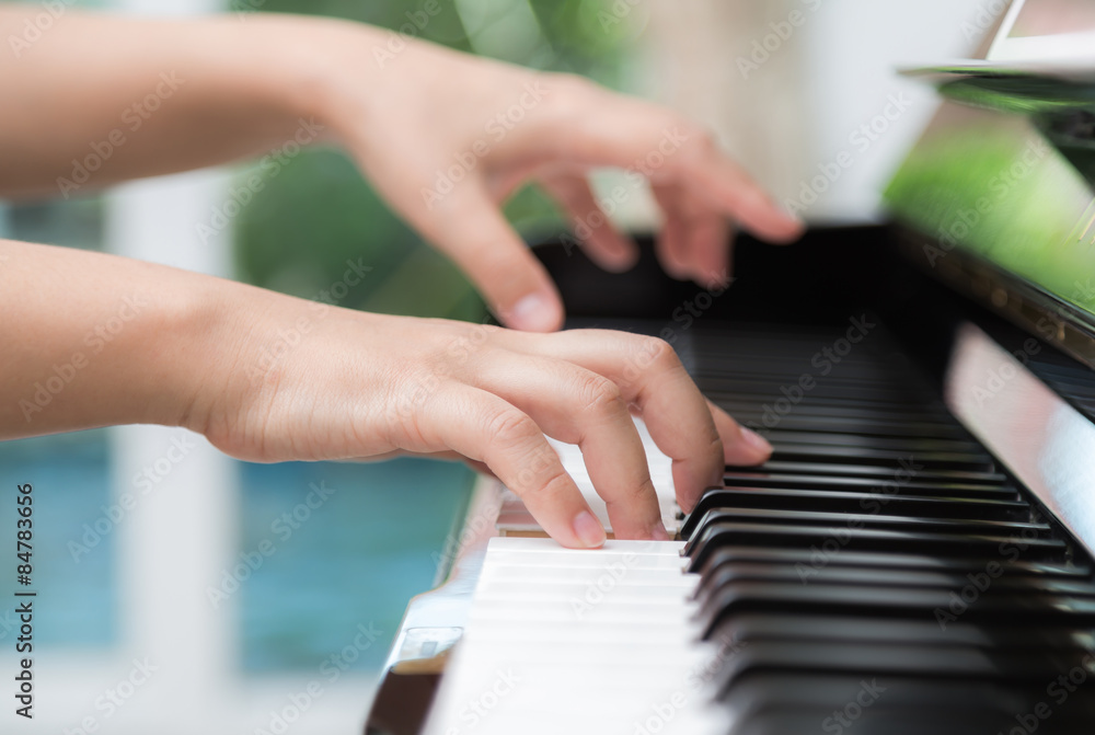 Obraz premium Close up of woman hands playing piano
