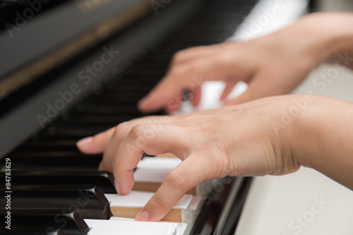 Close up of woman hands playing piano