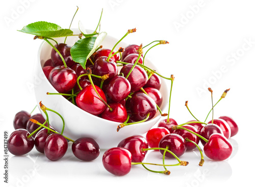 fresh cherry berries with green leaf isolated on white photo