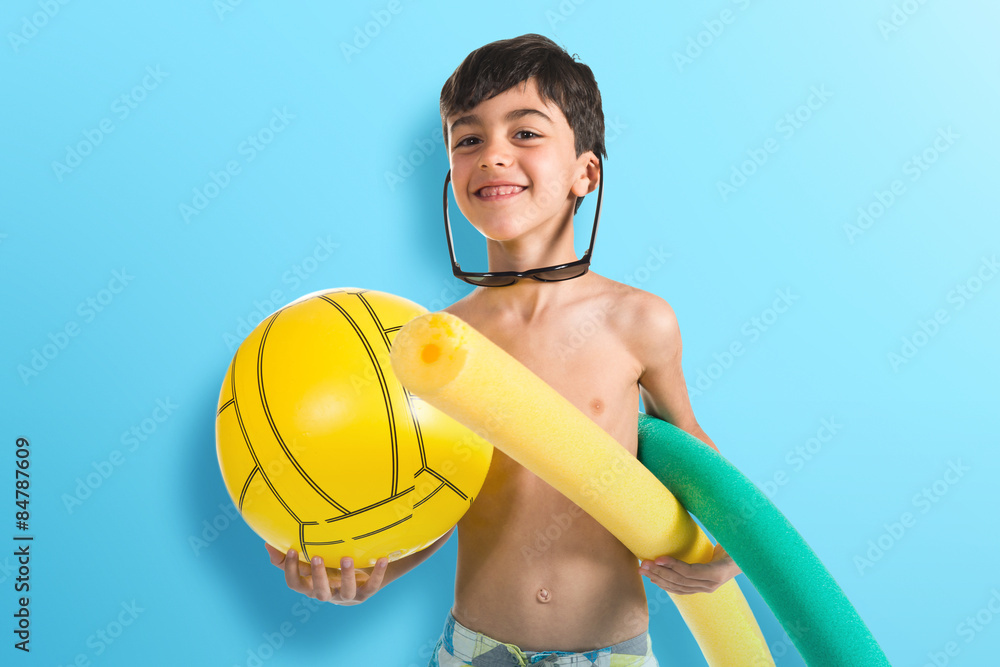 Child holding beach elements