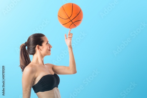 Woman playing baktetball © luismolinero