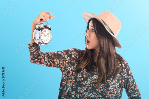 Photos Surprised woman holding vintage clock