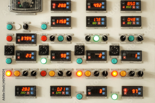 Industrial factory control panel with switches and digital indicators