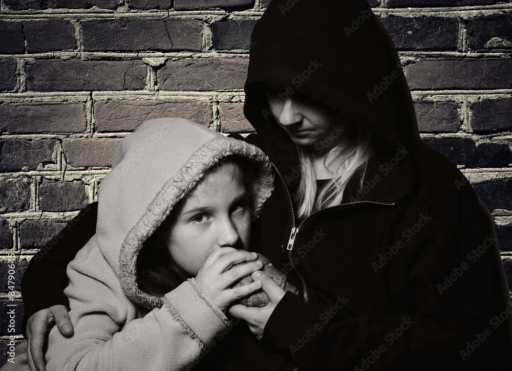 Homeless mother with her daughter. Poor family.