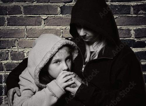 Homeless mother with her daughter. Poor family.