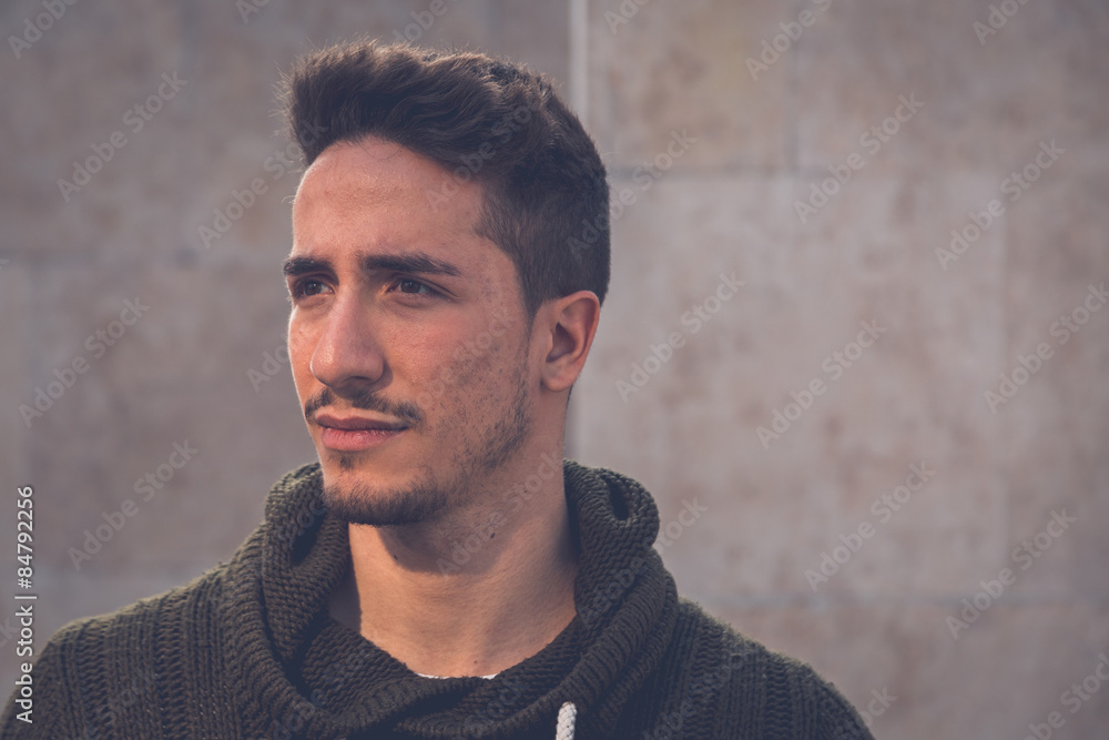 Young man posing in an urban context Young man posing in an urban context