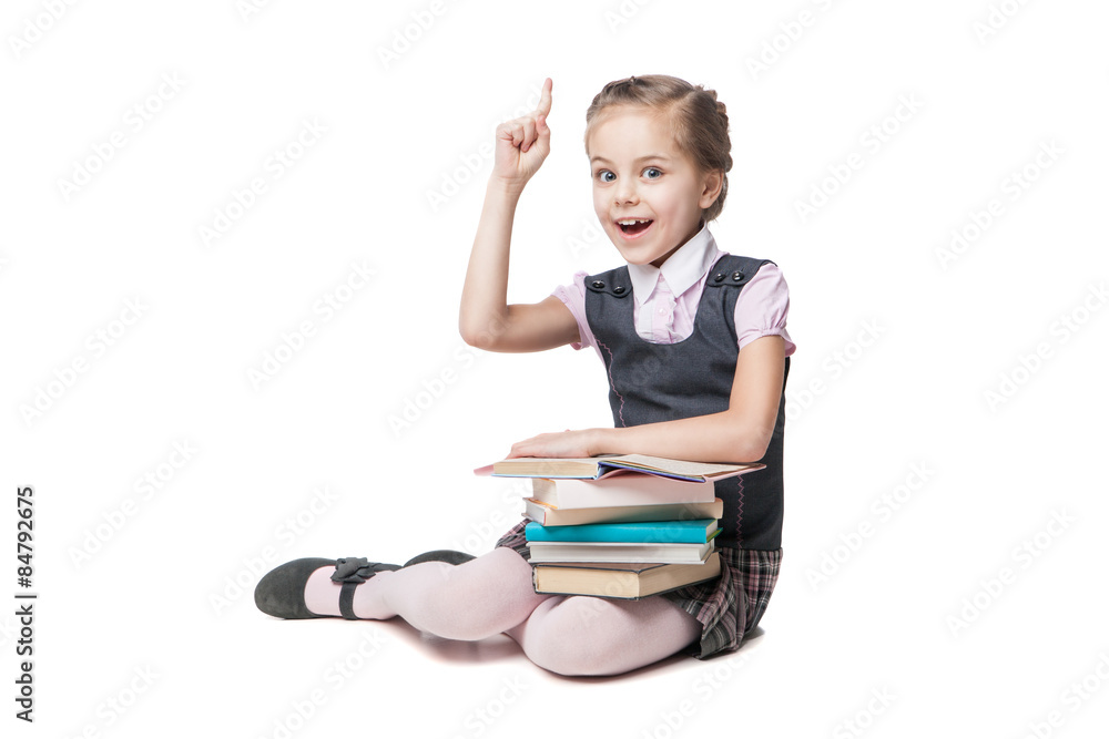Beautiful little girl in school uniform with books sitting on Beautiful little girl in school uniform with books sitting on