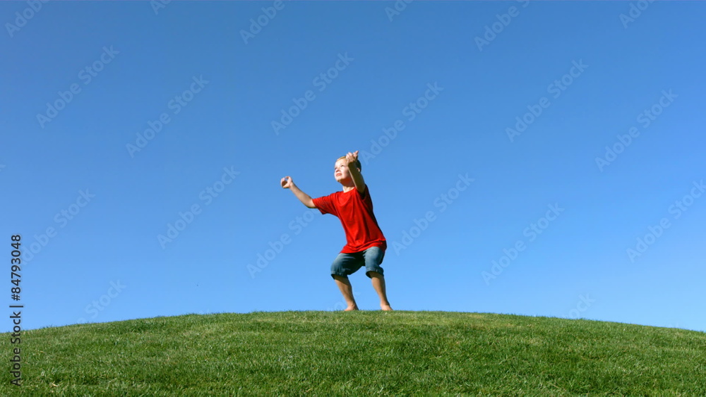 Young boy jumping on a hilltop. Slow motion. Young boy jumping on a hilltop. Slow motion.