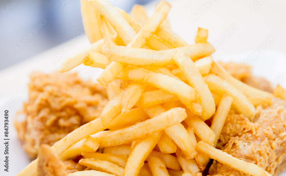 French fried with crispy fried chicken closeup French fried with crispy fried chicken closeup