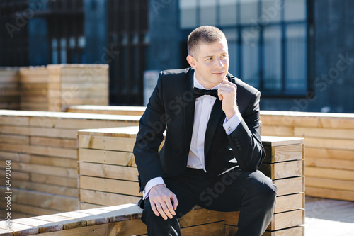 Maxim photo session model in tuxedo outdoors