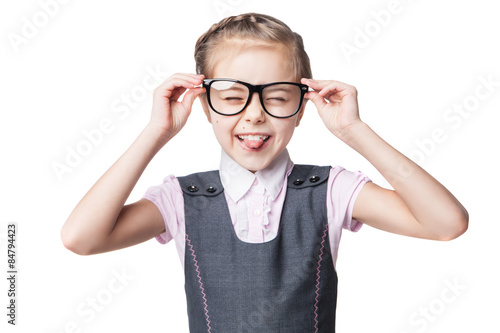 Funny little girl in glasses makes faces