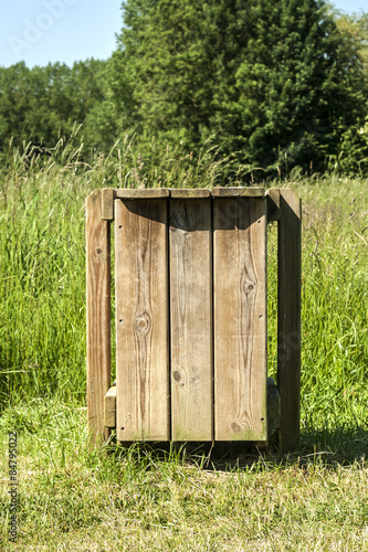 wooden garbage container in a park