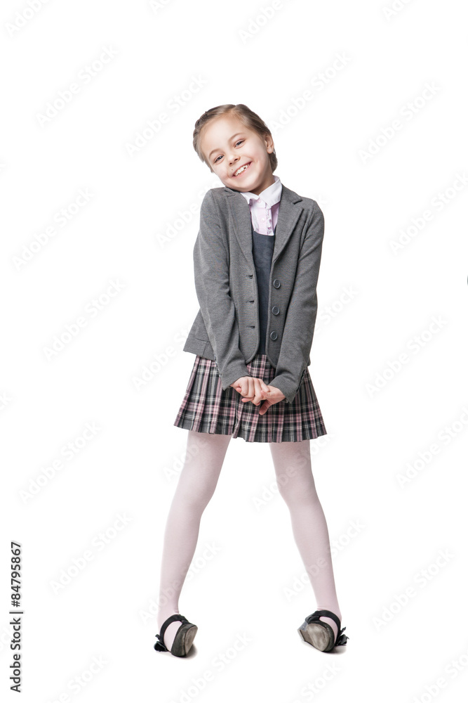 Fototapeta premium Beautiful little girl in school uniform isolated on white