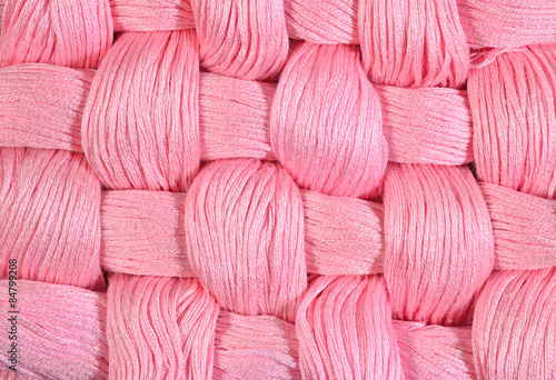 Pink twisted skeins of floss as background texture