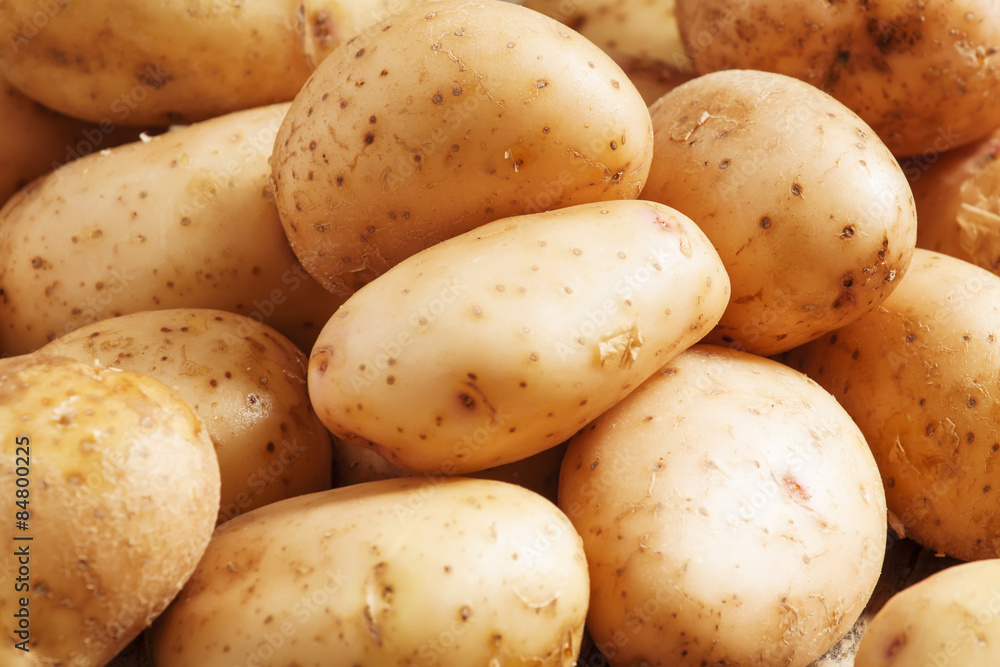 Fresh potatoes in an old wooden table, selective focus Fresh potatoes in an old wooden table, selective focus