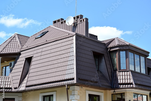Mansard floor of a mansion with a roof from a metal tile
