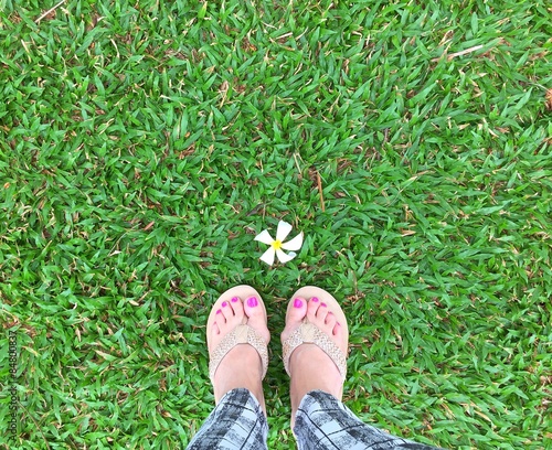 feet on green grass. 