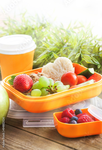 Lunch box with sandwich, cookies, veggies and fruits