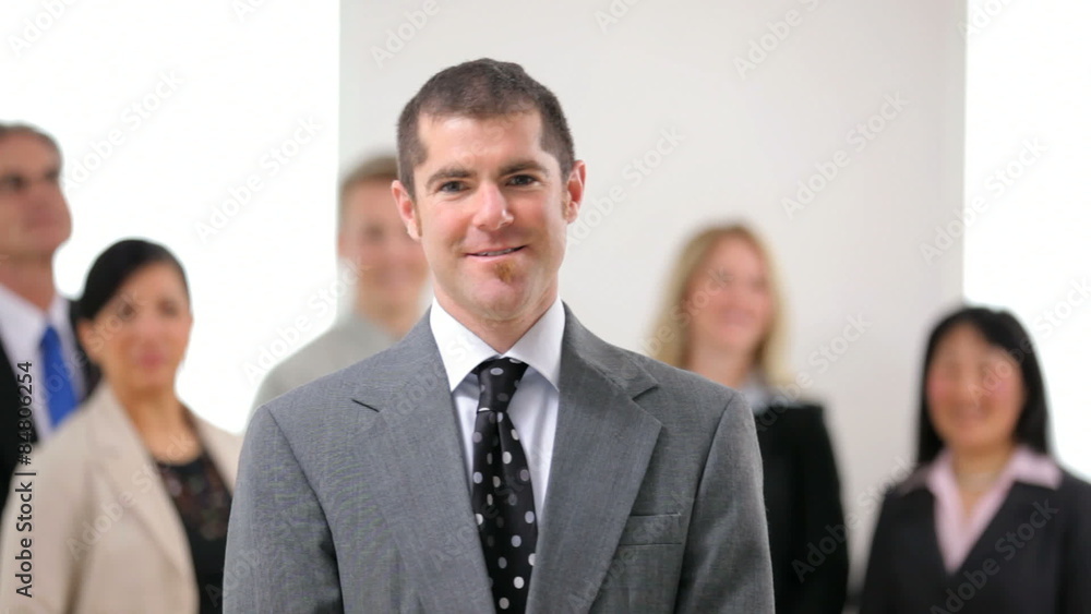 Portrait of business man with co-workers in background Portrait of business man with co-workers in background
