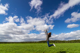 девочка подросток в прыжке на летнем поле