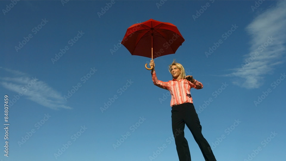 Happy woman flying with umbrella 