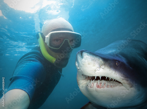 Underwater selfie with friend. Scuba diver and shark in deep sea. photo