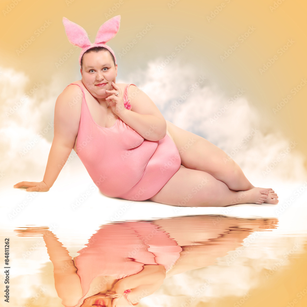 Overweight woman in swimmsuit relaxing on the beach. Overweight woman in swimmsuit relaxing on the beach.