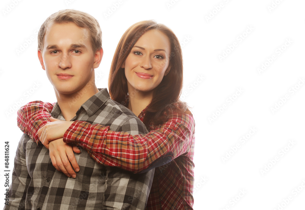 lovely happy couple hugging over grey background. lovely happy couple hugging over grey background.