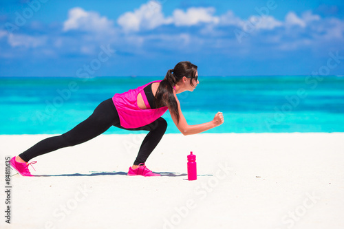 Healthy athlete woman working out doing exercise on white beach