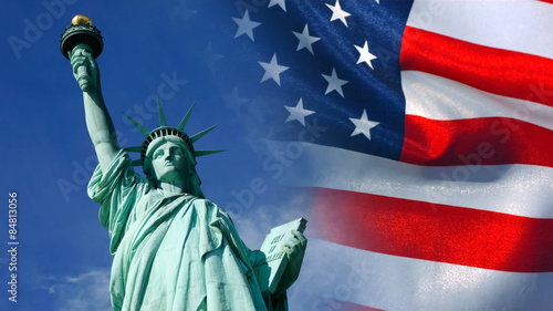 Statue of Liberty and United States flag waving in wind