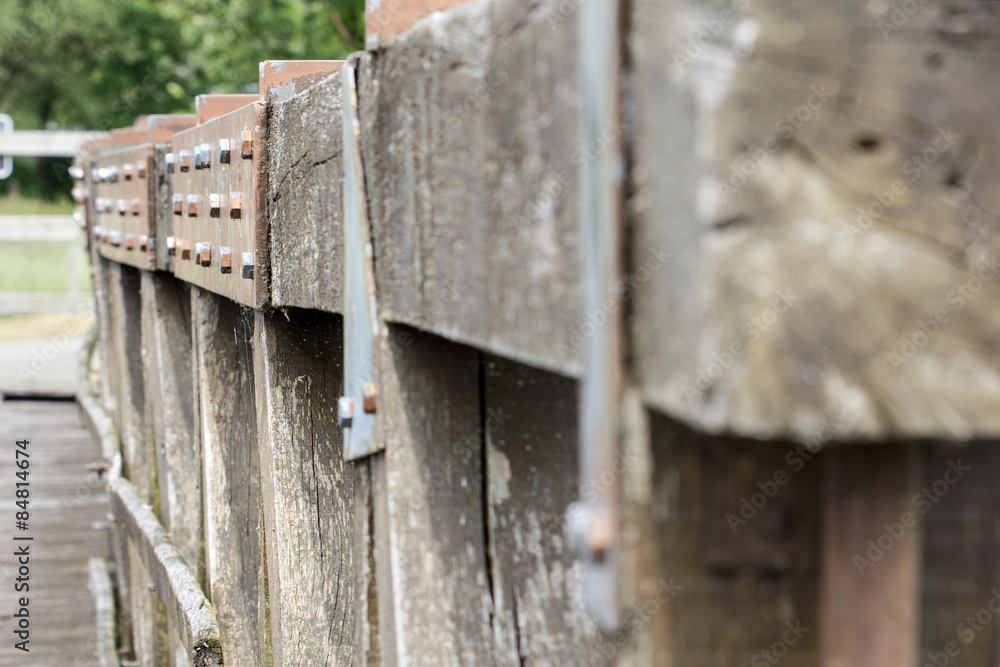 Detail of a wooden bridge / Detail of a wooden bridge with trees and lawn